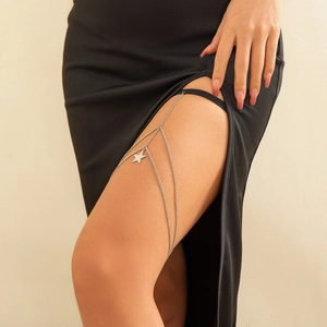 Detailed close-up of a silver star pendant body chain with an elastic black thigh band