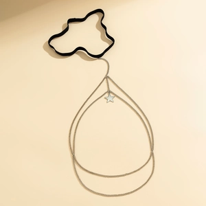 Detail of silver star pendant on double-layer metal thigh chain with black elastic band