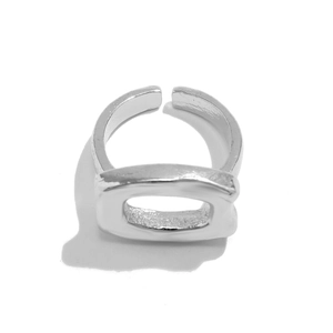 Macro view of silver metallic adjustable bow ring with textured hollow rectangle design