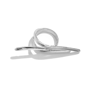 Macro detail of sculptural silver bow ring with polished metallic finish and shadow