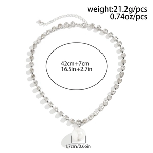 Detail view of gothic layered necklace with rhinestone chain and large white pearl pendant
