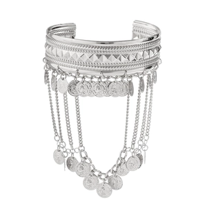 Detail view of Bohemian silver arm cuff with coin tassels and engraved patterns