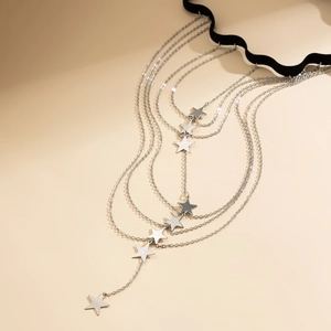 Close-up of multilayer star fringe leg chain with silver metal chains and star charms