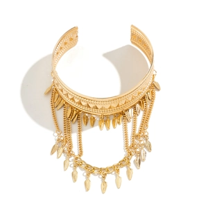 Detailed close-up of Bohemian gold arm chain featuring embossed patterns and fringe tassels