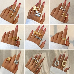 Collection of modern metallic butterfly and geometric rings in gold and silver finishes