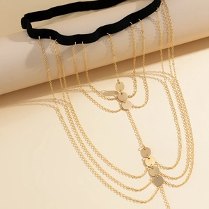 Detail of multi-layer gold leg chain with elastic band and polished metal sequins