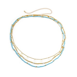 Detail of bohemian layered waist chain with blue beads, pearls and sequins