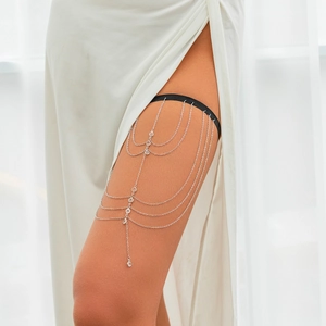 Detail of silver layered thigh chain with butterfly tassels and sparkling rhinestones