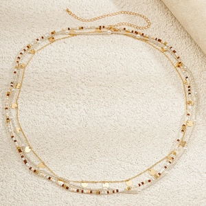 Detail of bohemian layered waist chain with colorful beads and gold metal sequins