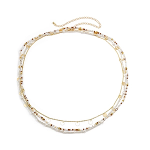 Detail of bohemian gold waist chain with multi-layer seed beads and shiny sequins
