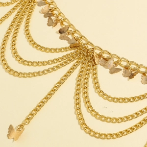 Detailed macro view of multi-layered gold chain with delicate metallic butterfly pendants