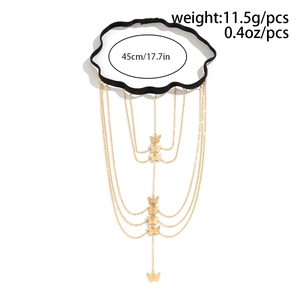 Detail of black elastic leg chain with layered gold butterfly pendants and star charms