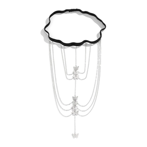 Detail of multi-layer silver butterfly pendants on an elastic punk style leg chain