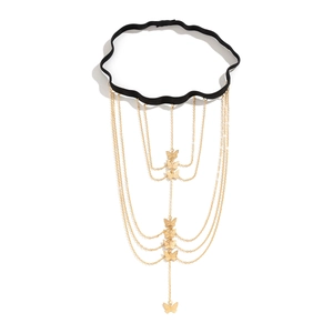 Detail of golden butterfly tassel leg chain with elastic black band and multi-layer fringe