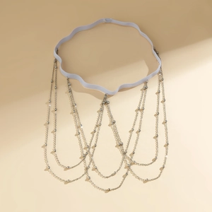 Detail of layered silver beaded leg chain tassels with elastic white band