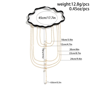 Detailed view of elastic leg chain with golden tassels, white pearls and size specifications