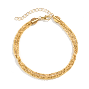 Detail of a triple-strand gold woven ankle chain with lobster clasp and extension link