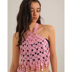Detail of a pink heart sequin halter top featuring hollow out metal ring link design