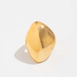 Détail macro d'une bague lave dorée polie avec une forme organique liquide unique
