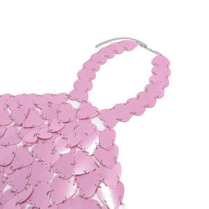 Detail of pink heart-shaped sequin top with metal link chains for beachwear