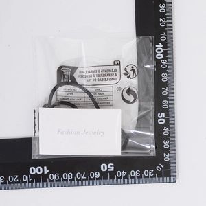 Detailed view of handmade black braided cord necklace on a fashion jewelry display card