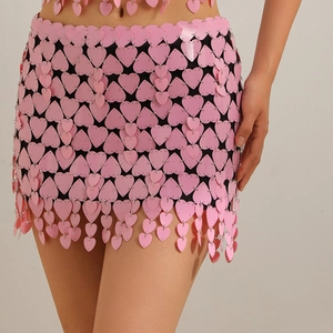 Detail of pink heart-shaped sequin mini skirt with metallic rings for beach party wear