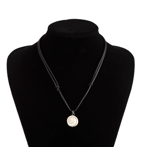 Detail of bohemian shell pendant on black wax cord displayed on a velvet bust