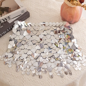 Detailed view of silver heart sequins connected by metal rings for a sparkly body chain