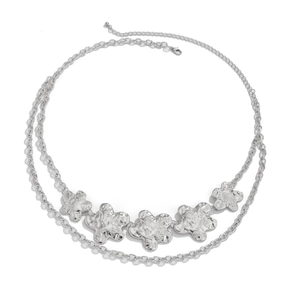 Detail of silver double-layer waist chain with textured floral pendants and lobster clasp
