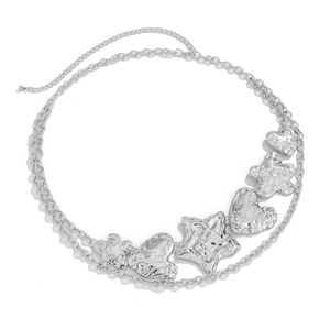 Detail of silver heart and starfish charms on a layered metallic waist chain