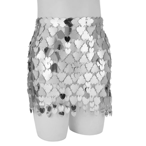 Macro detail of silver heart-shaped sequins linked by metallic rings on a body chain