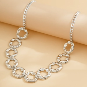 Silver metallic body chain with hammered irregular ring links on a display stand