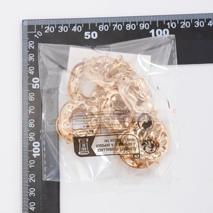 Detail of gold textured rings for body chain accessory showing the wavy metal surface