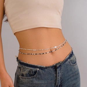 Detail of double-layer seed bead body chain with shell and starfish accents on waist