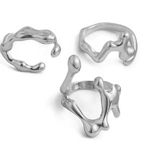 Detailed view of three silver liquid lava rings with irregular flowing textures on white background