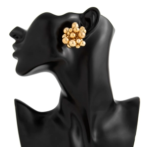 Detail of geometric gold beaded cluster earrings with polished mirror finish on model
