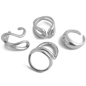 Macro shot of four silver-tone liquid lava rings with irregular polished fluid designs