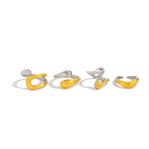 Detail of four minimalist lava-style rings in mixed gold and silver fluid metal finish