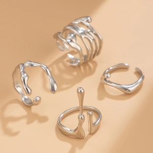Macro detail of silver liquid lava irregular open rings set with polished finish