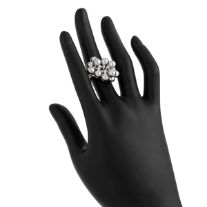 Detail shot of silver bead cluster ring on a black hand model for a metallic fashion look