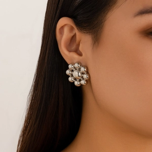 Silver bead flower earrings worn by a model showcasing geometric metallic cluster design