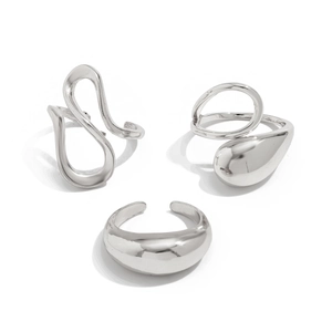 Macro detail of three silver liquid lava rings with irregular open designs on white background