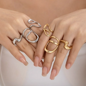Irregular wavy lava rings set in gold and silver finish on hand for women