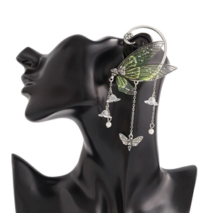 Detail of elf butterfly ear cuff with green wings, tassels, and pearl flower charms