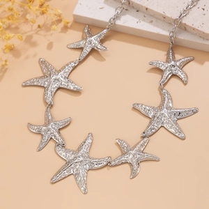 Detailed macro shot of silver starfish waist chain with intricate textured finish