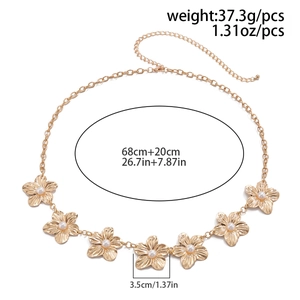 Detail of gold metal flower body chain with white pearls and adjustable lobster clasp