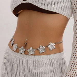 Detail of silver metal body chain featuring pearl flower charms on a knit dress