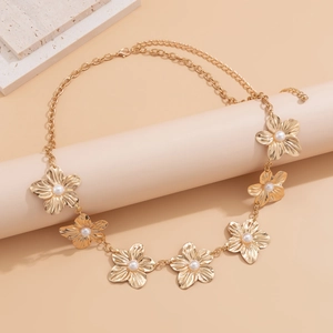 Detail of gold flower body chain with white pearls and adjustable lobster clasp closure