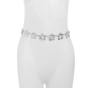 Close-up of silver metal flower body chain with elegant white pearls on white model