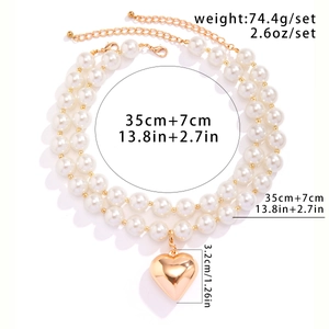 Detailed view of layered pearl necklace with gold heart pendant and sizing dimensions